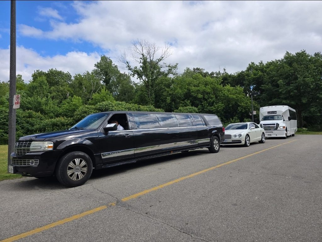 Galaxy Limo fleet lineup with a black Lincoln Navigator stretch limo, white Bentley and limo bus