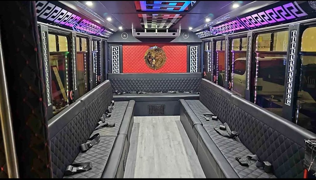Party bus interior with LED lighting and wraparound seating for bachelor and bachelorette parties