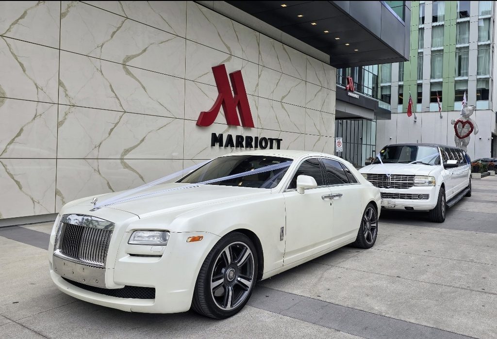 Rolls Royce and stretch limousine waiting outside a downtown Toronto hotel