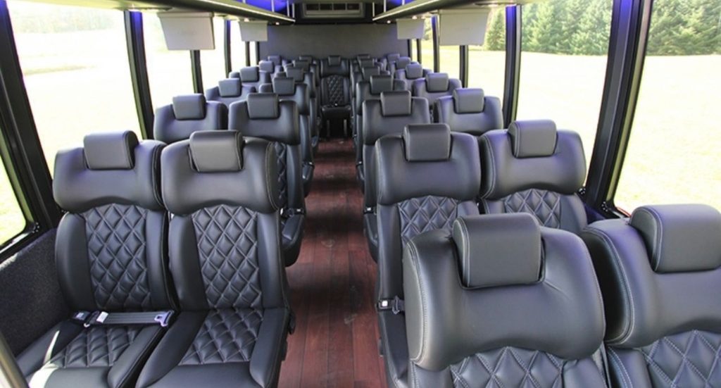 Executive shuttle bus interior with quilted leather reclining seats